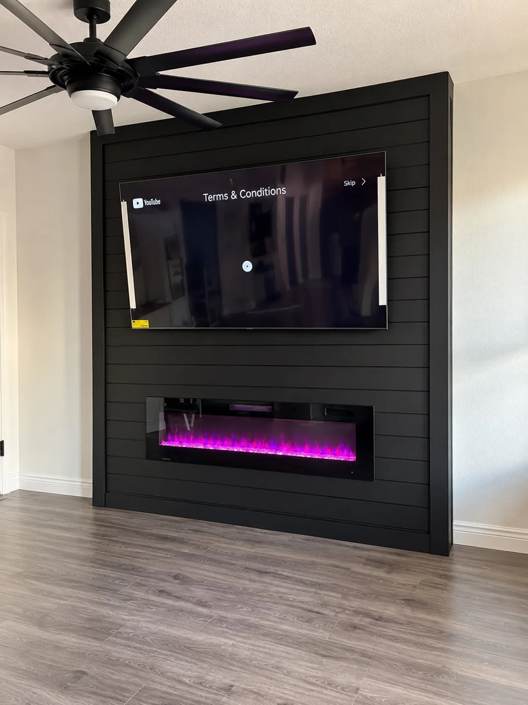 Black custom TV wall with electric fireplace