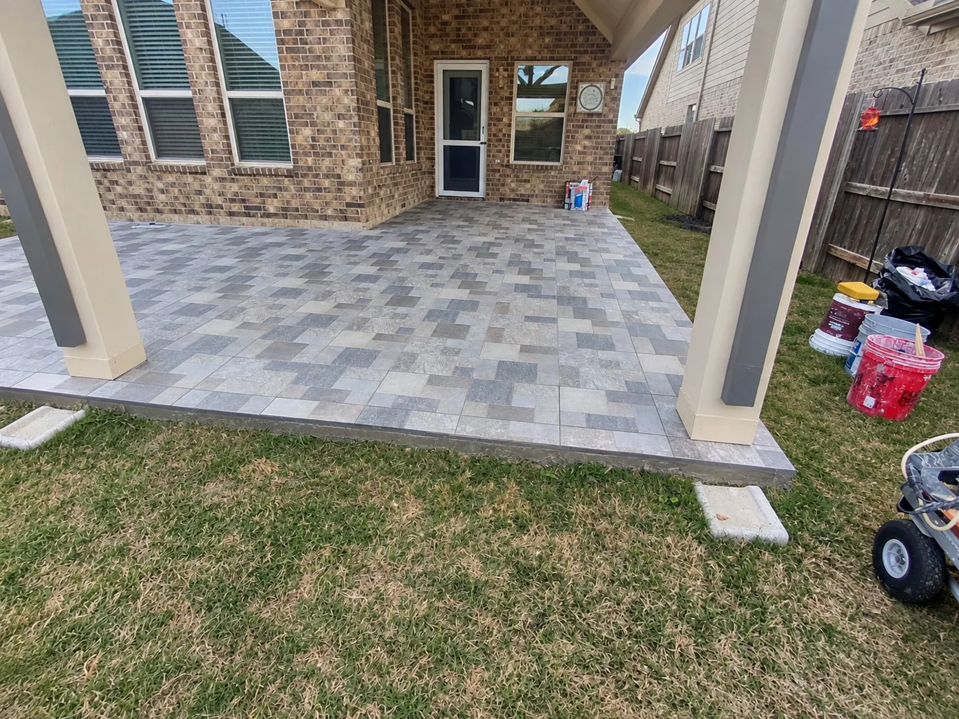 Covered backyard patio with patterned tile installation